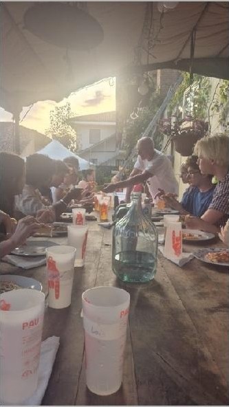 A long shared table at dusk during the ECOFestival