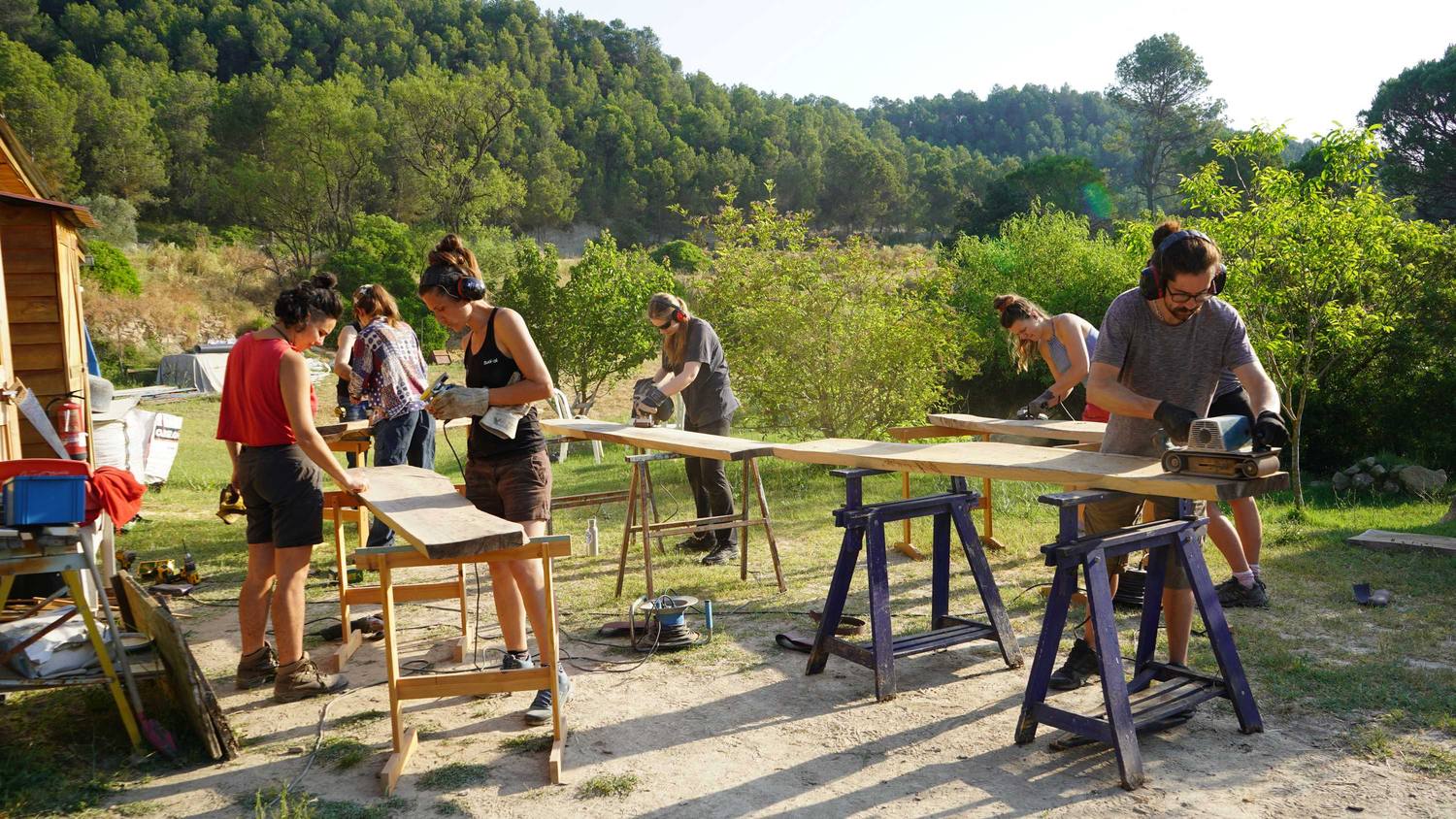 Participants building together at outdoor work tables