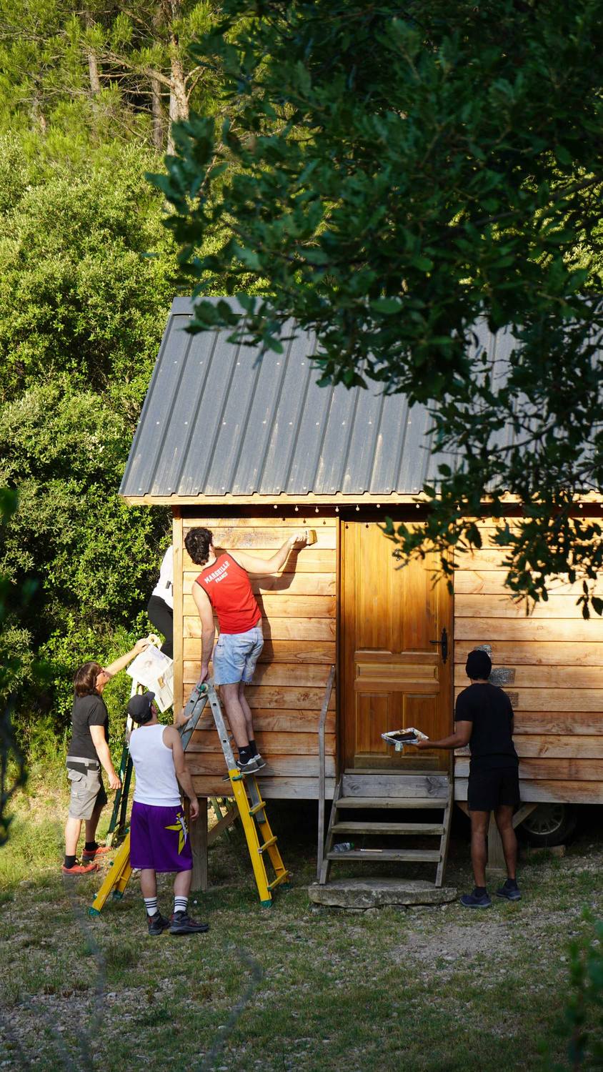 Participants working on a timber cabin